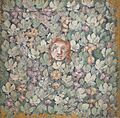 Pompeii — Mask amid bunches of grapes and vines