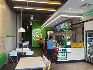 Counter and customers, new-style Subway restaurant