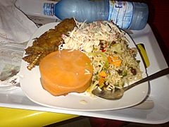 Jamaican Rice served with grilled Fish and Mixed Salad and moi moi (Baked beans)
