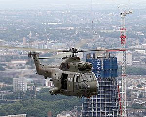 Royal Air Force 230 Squadron Puma HC1 flying past The Shard skyscrape
