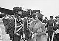 The Queen and Princess Elizabeth talk to paratroopers in front of a Halifax aircraft during a tour of airborne forces preparing for D-Day, 19 May 1944. H38612
