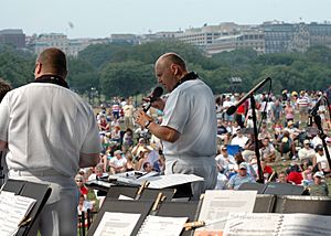 US Navy 070704-N-2240E-004 Senior Chief Musician John Fisher performs with the U.S. Navy Band Cruisers contemporary music ensemble at the Sylvan Theater on the grounds of the Washington Monument for the Fourth of July