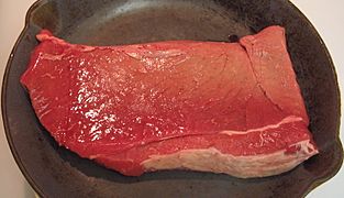 Beef round top round steak in pan, raw