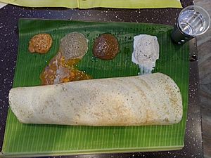 Dosa with chutney and sambar traditionally served in banana leaf
