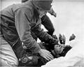 Joseph T. O'Callahan gives last rites to an injured crewman aboard USS Franklin (CV-13), 19 March 1945