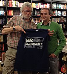 Mr Iain M Banks accepting a T shirt conferring the title Acting Honorary Non-Executive Figurehead President Elect pro tem (trainee) of the ScienceFictionBookClub.org - October 2012