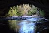 Oparara River flowing out of Moria Gate arch.jpg