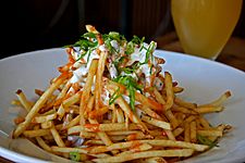 Shoestring fries, garlic, homemade blue cheese dressing, with some spicy sauce