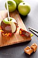 Sliced caramel apple on wooden cutting board (11213730635)