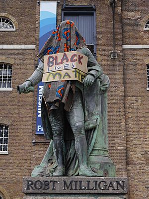 Statue of Robert Milligan, West India Quay on 9 June 2020 - statue covered and with Black Lives Matter sign 03
