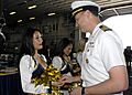 US Navy 090206-N-8283S-185 Capt. Frank Michael, executive officer of the amphibious assault ship USS Boxer (LHD 4), presents a command coin to each member of the San Diego Chargers cheerleaders during their visit aboard Boxer