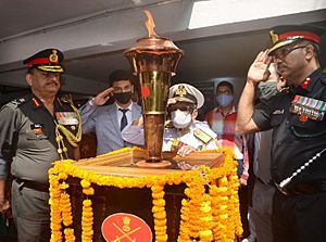 Commander of the Eastern Naval Fleet during the 1971 War, Vice Admiral S.H. Sarma, and Tri-Services personnel salute the Swarnim Vijay Varsh Victory Flame at Sarma's home in Odisha