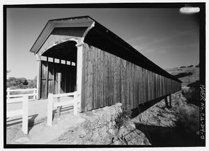 OBLIQUE PERSPECTIVE SOUTHEAST PORTAL, WEST BY 290 DEGREES - Knight's Ferry Bridge, Spanning Stanislaus River, bypassed section of Stockton-Sonora Road, Knights Ferry, Stanislaus County, HAER CA-314-3