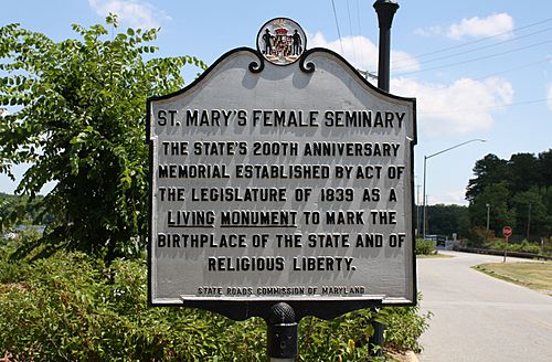 Official state of Maryland historic monument sign citing original designation of Mary's Female Seminary as a "Living monument to the birthplace of the state and religious liberty."