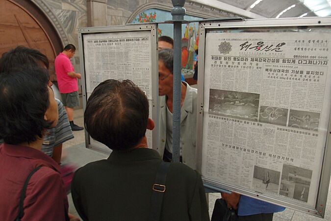 Public newspaper reading stand in Pyongyang metro 3