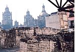 Foreground: ruins of Templo Mayor. Background: Mexico City Metropolitan Cathedral