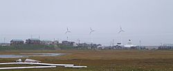 Hooper Bay with wind turbines in background.