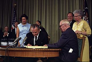Lyndon Johnson signing Medicare bill, with Harry Truman, July 30, 1965