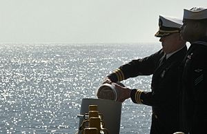 US Navy 080211-N-3659B-085 Cmdr. Lee Axtell, command chaplain aboard the Nimitz-class aircraft carrier USS Ronald Reagan (CVN 76), releases the ashes of retired U.S. Navy captain and astronaut Walter M. (Wally) Schirra