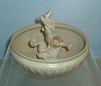 Yuan celadon bowl with modeled dragon design