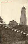 Black and white postcard of the wooden lighthouse at the top of the harbour at Port Burwell, ON. The road runs down to the bridge over Otter Creek.jpg