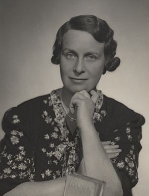 Black and white portrait photograph of Haslett taken about 1924. She is looking into the camera, wearing a dress and resting her chin on her hand.