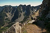 Mountainside trail with view of jagged rocky mountain with steel talus