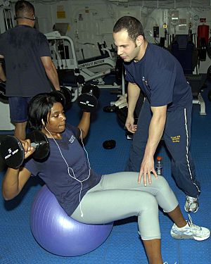 Weighted sit-ups on an exercise ball