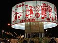 A large round white fabric band decorated with red figures and images for Tết 