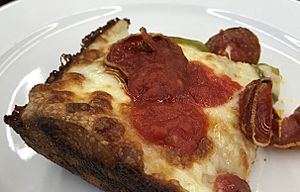 Detroit-style pizza showing typica lacy cheese crust