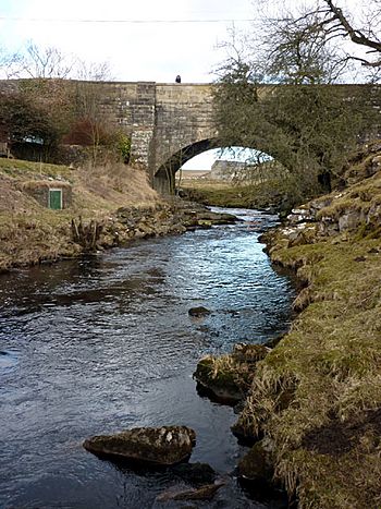 A stone arch bridge over a beck