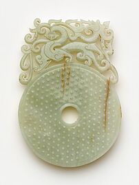 Disk (bi) with knobs, feline and dragon