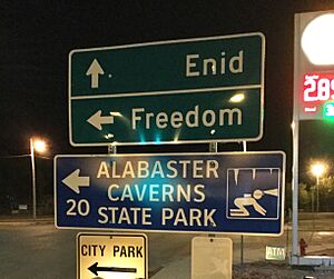 Sign pointing to Enid, Freedom, and Alabaster Caverns along highway 412