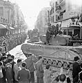 A Churchill tank and other vehicles parade through Tunis, 8 May 1943. NA2880
