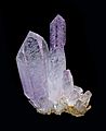 A cluster of light purple to violet amethyst crystals.
