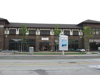 Image of a two-story brown commercial building with two small towers