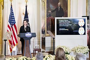 Lisa Mosconi standing behind a podium in front of a slide showing her research