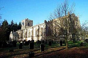 A long stone church seen from the southeast with a low tower at the far end