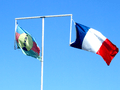 Two official flags of New Caledonia on same flagpole