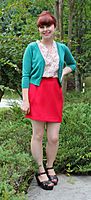 Woman in a red miniskirt and green cardigan crop