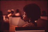 Profile of a Black woman sitting in a church pew