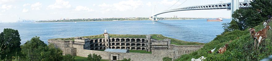 Panorama of the Upper New York Bay viewed from Staten Island. The Verrazano-Narrows Bridge is visible in the center of the image and Fort Wadsworth is visible in the foreground.