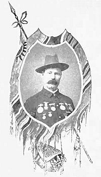 Framed portrait of a white man with a mustache, cavalry hat, and an array of medals across his chest