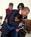 President Obama greets a young girl who was the guest of Nobel Peace Prize winner Kailash Satyarthi in New Delhi