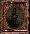 Three quarter length portrait, young solder seated, kepi and cigar. Cased tintype, sixth plate