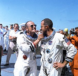 Astronaut Charles Conrad Jr. tweaks astronaut L. Gordon Cooper's eight-day growth of beard for the cameramen
