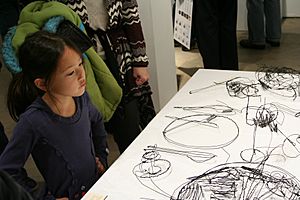 Girl looks at Wire Scribble Sculpture