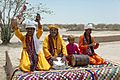A group of folk singers in the Cholistan Desert with unique musical instruments