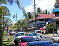 Photograph of a street in Lāhainā, with cars, pedestrians, and historic buildings.