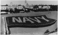 Navy personnel on parade at Balboa Park in Navy flag formation, San Diego, California. - NARA - 295555